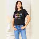 Women's Simply Love tee featuring colorful graphic text on a black background, perfect for casual outings.