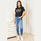Trendsi Simply Love tee in black featuring colorful text, paired with blue skinny jeans
