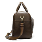Soft leather travel duffel bag in brown with sturdy handles and adjustable strap for easy carrying