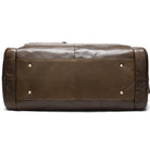 Bottom view of a soft leather travel duffel bag showcasing durable design and secure studs