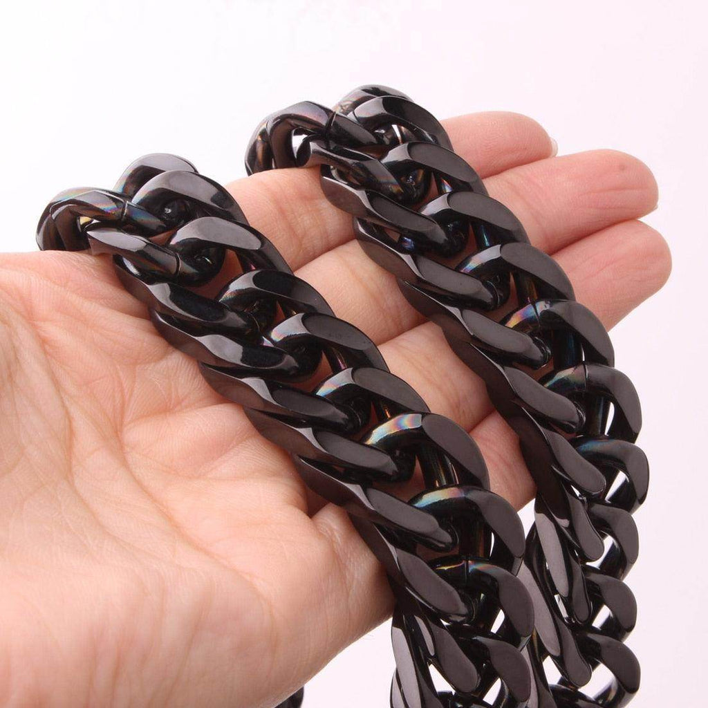 Hand holding a Stainless Steel Cuban Link Necklace showcasing its sleek design and durable finish