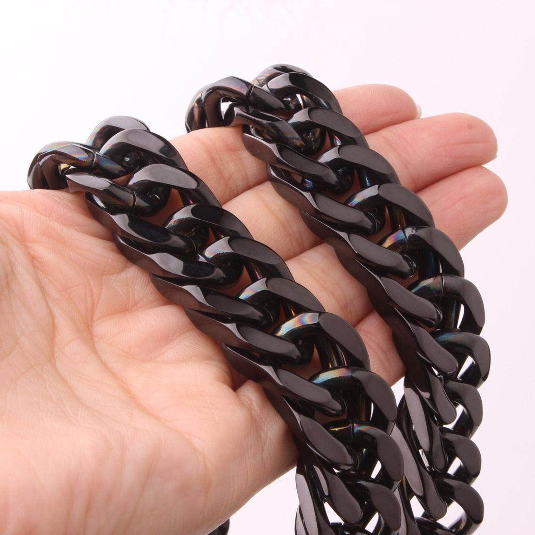 Hand holding a Stainless Steel Cuban Link Necklace showcasing its sleek design and durable finish