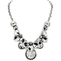 Elegant statement white metal necklace adorned with floral designs and sparkling crystals