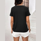 Back view of a black stylish lace trim shirt paired with white denim shorts