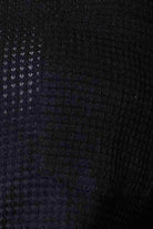Close-up of a textured fabric in a black stylish vacation sweater by Trendsi
