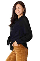 Stylish vacation sweater from Trendsi with a black knit design and button details, perfect for warm weather outings.