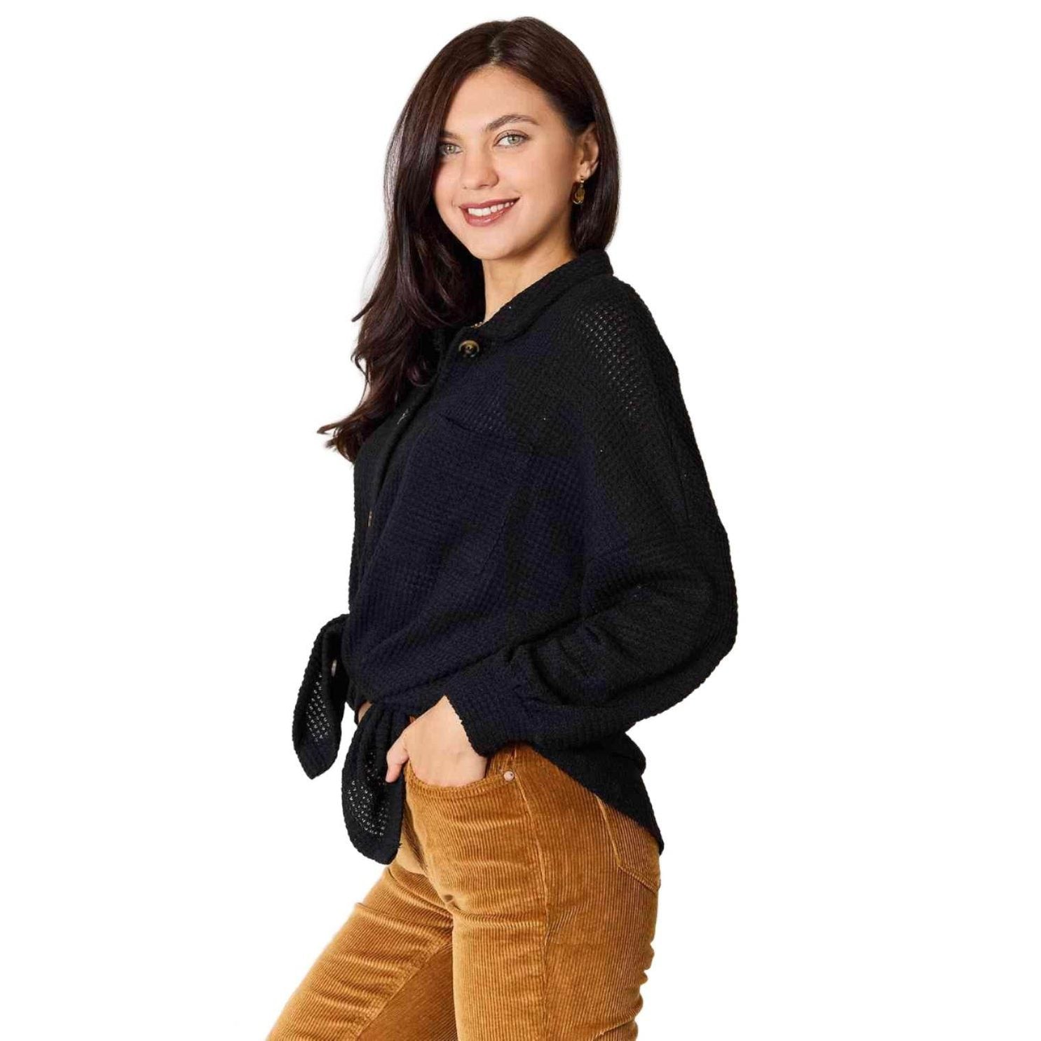 Stylish vacation sweater from Trendsi with a black knit design and button details, perfect for warm weather outings.