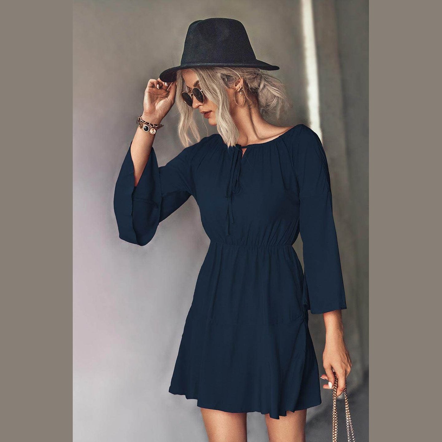 Navy tie neck vacation dress with bell sleeves and a flattering fit for summer outings