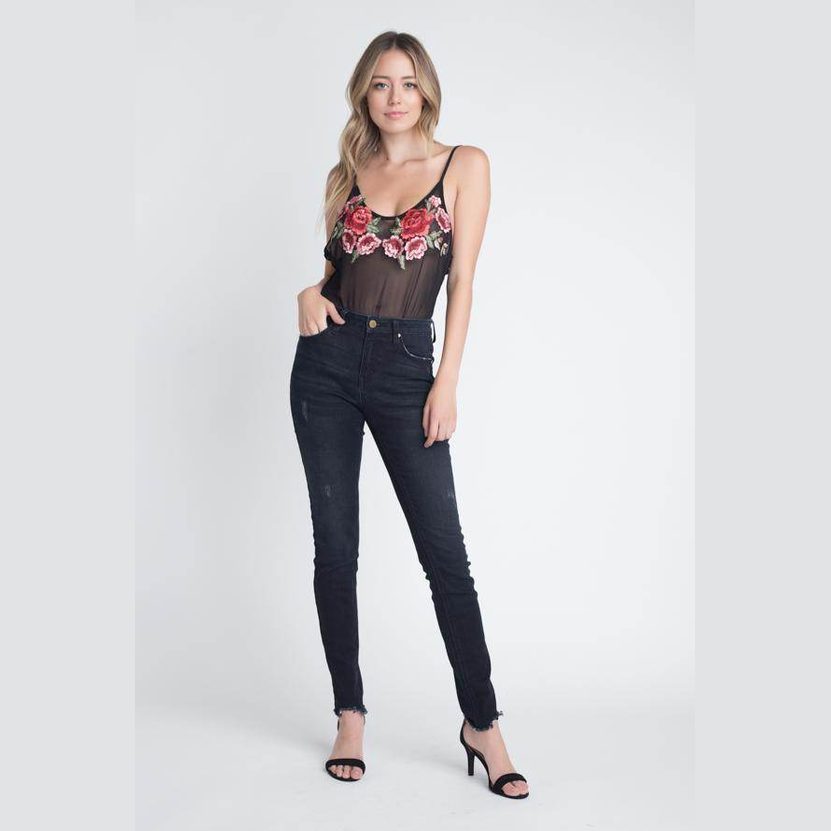 Ivory Felix transparent floral blouse in black with rose design, paired with dark skinny jeans