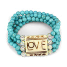 Turquoise beaded brass bracelet featuring a central LOVE charm and shimmering accents