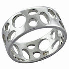 Unique cut out silver band for women featuring circular designs in polished metal finish