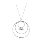 Unique vacation jewelry for her featuring a silver hoop necklace with colorful stone accents