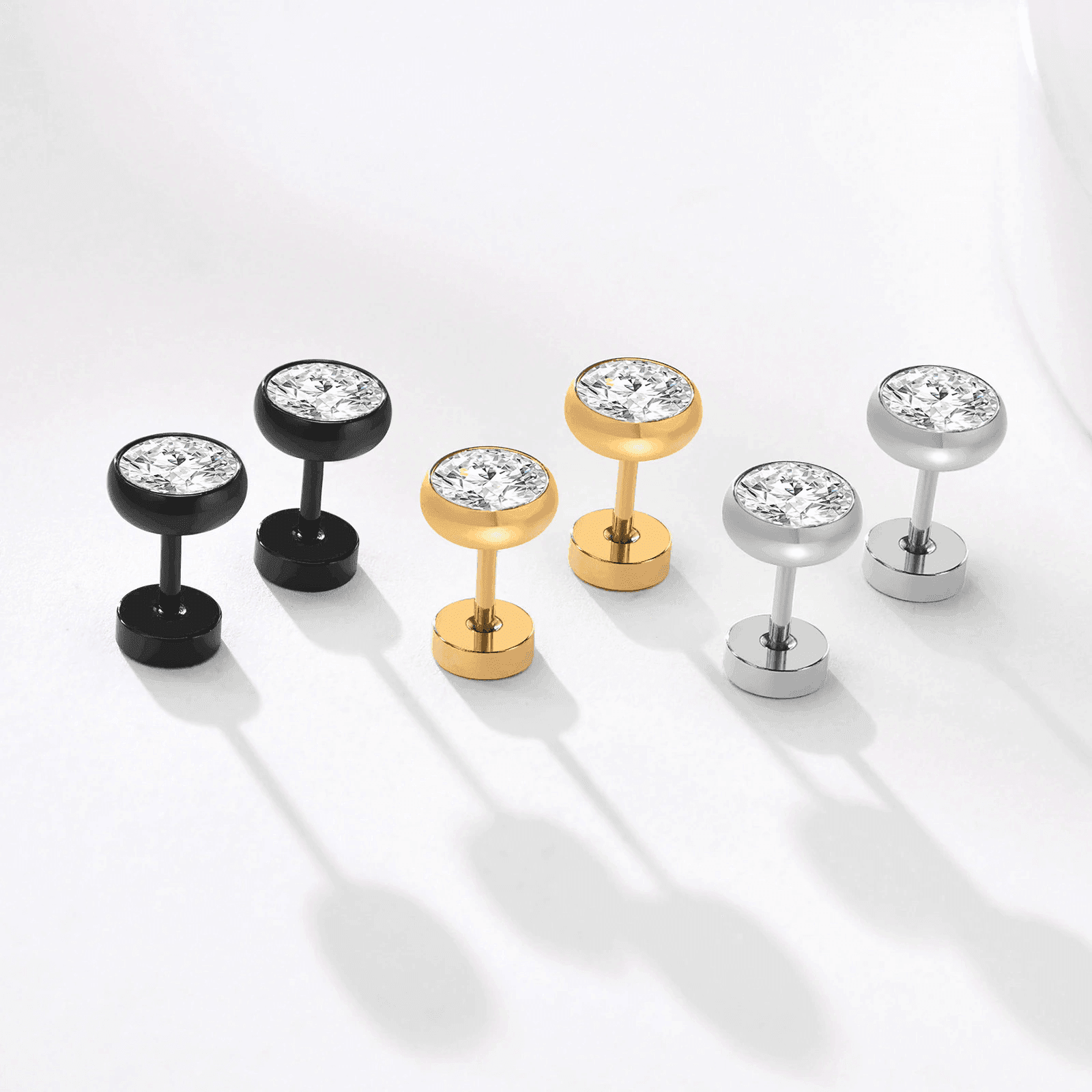 Stylish men's earrings in black, gold, and silver featuring sparkling diamonds, perfect vacation jewelry for men