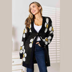 Trendsi vacation style floral cardigan featuring smiley daisies on a black background for cheerful outfits