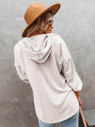 Women's vacation style hoodie in soft beige with a relaxed fit and attached hood