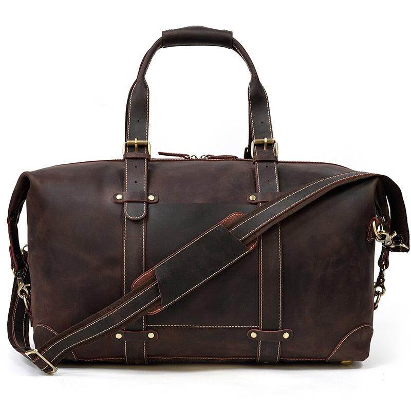 Vacation style leather bag in dark brown with sturdy handles and adjustable shoulder strap