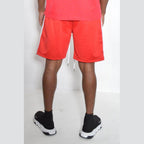 Men's red shorts with white side stripes for a vacation style mens shorts look
