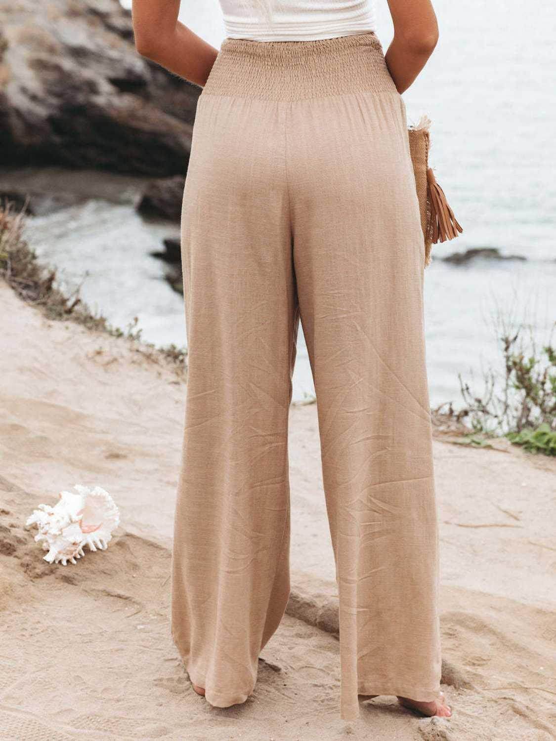 Back view of women's vacation style wide leg trousers in beige, perfect for beach outings or casual summer days