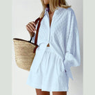 Light blue women's lantern sleeve shirt and shorts set styled with a straw bag, perfect for summer outings