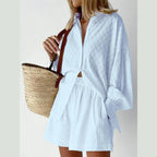 Light blue women's lantern sleeve shirt and shorts set styled with a straw bag, perfect for summer outings