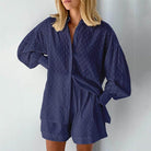 Navy women's outfit featuring a lantern sleeve shirt and shorts for stylish summer look