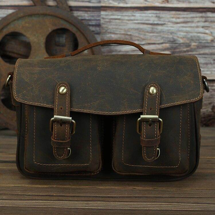 Vintage leather camera bag with dual front pockets and sturdy handle for photography enthusiasts
