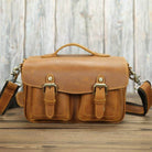Vintage leather camera bag with adjustable shoulder strap and multiple pockets for photographers