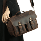 Vintage leather camera bag with dual front pockets and adjustable shoulder strap for photographers
