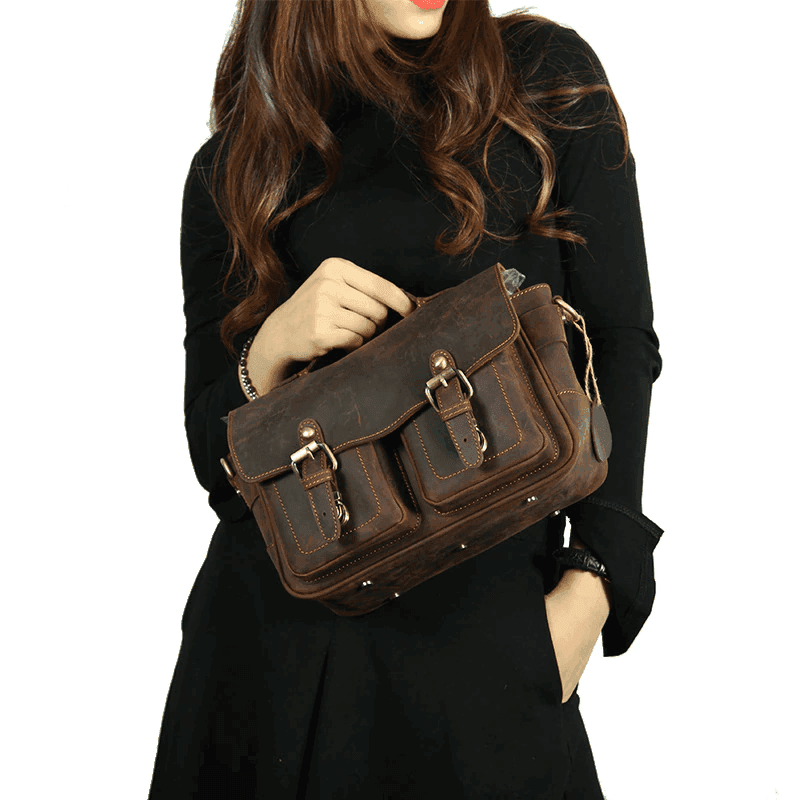 Vintage leather camera bag with adjustable shoulder strap and dual front pockets for photographers