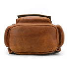 Front view of a vintage leather travel backpack in rich brown leather with spacious compartments