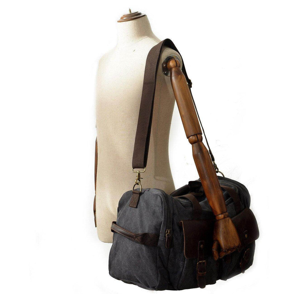 Stylish gray weekender outdoor duffel bag with brown leather accents and adjustable shoulder strap