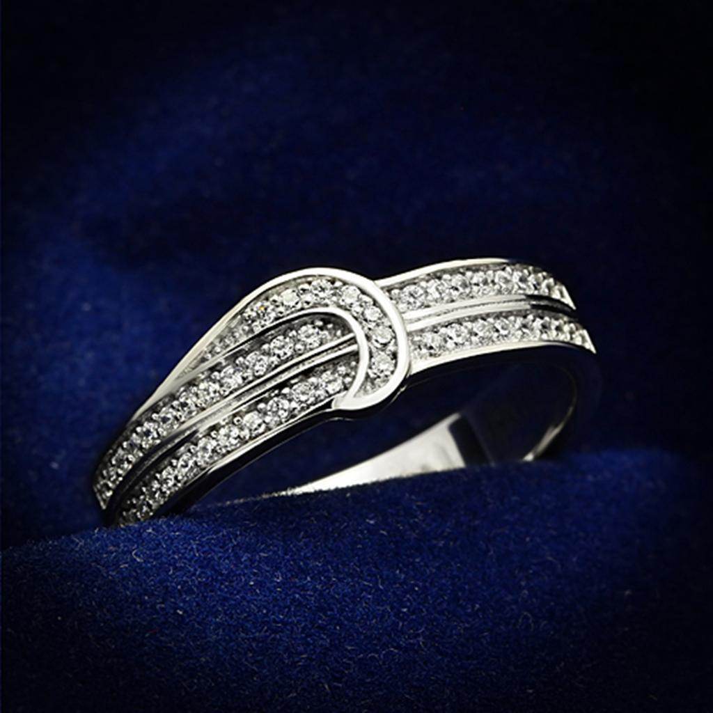 Elegant rhodium 925 sterling silver ring with sparkling stones on a blue velvet background