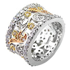 Stunning women's fashion brass ring with intricate silver and gold designs, adorned with sparkling stones.