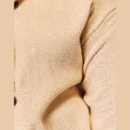 Beige woven long sleeve sweater with a relaxed fit and button details for casual wear